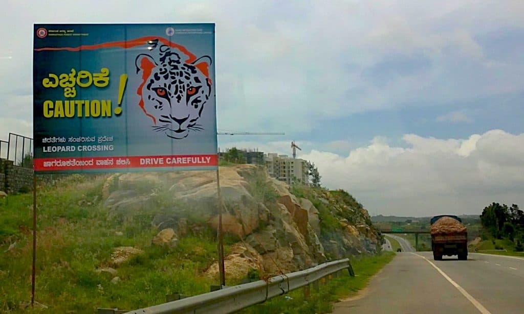 A signboard warning about leopard crossing