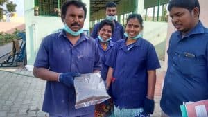 Workers of Division 19 at the Arulanandam Nagar Burial Ground happily display packets of compost produced at the facility. Pic: Aarti Madhusudan