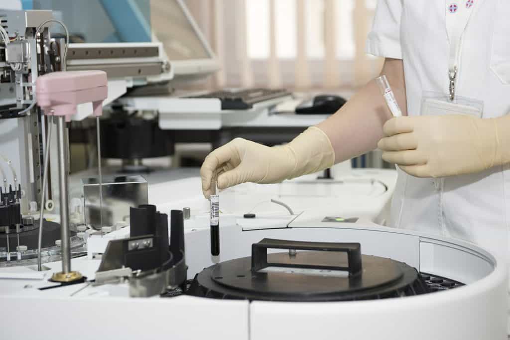 A medical professional handling blood samples.