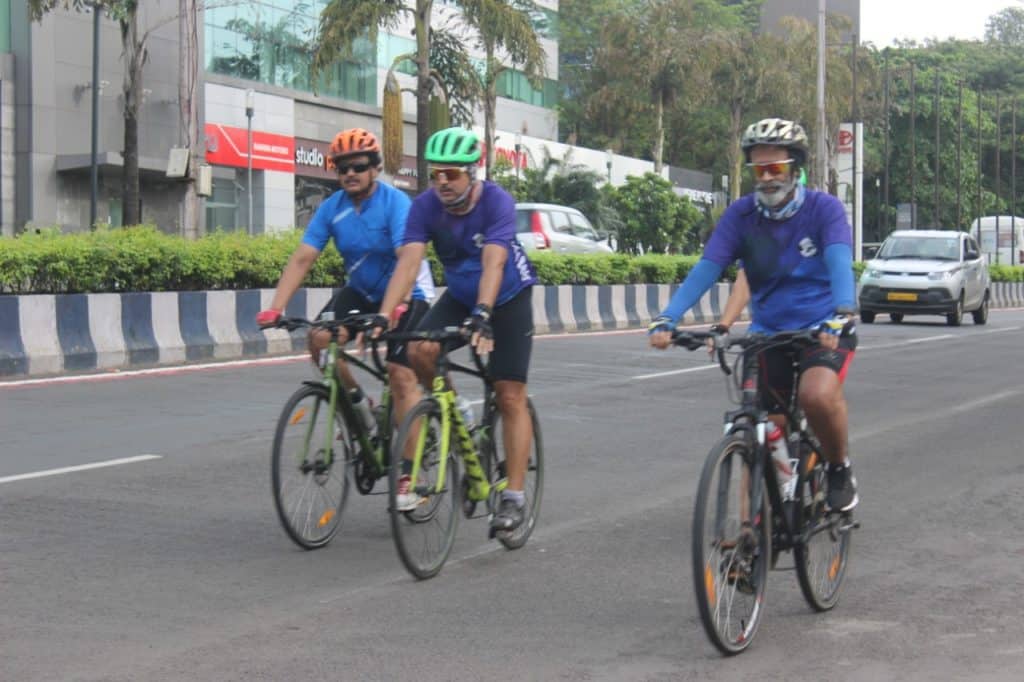 Cyclists on Pune's SB Road
