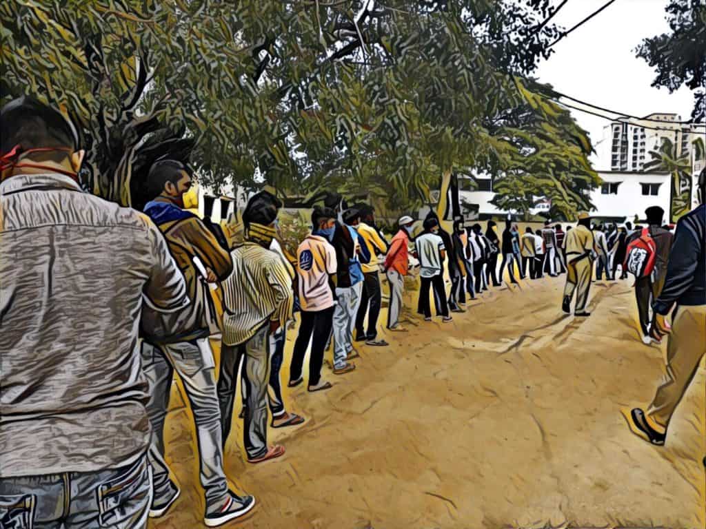 Migrants wait in line for information about Shramik trains in South Bengaluru. 
Photo: Lalitha Mondreti
