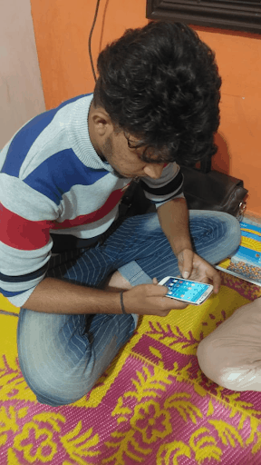 boy attending online classes on a mobile phone