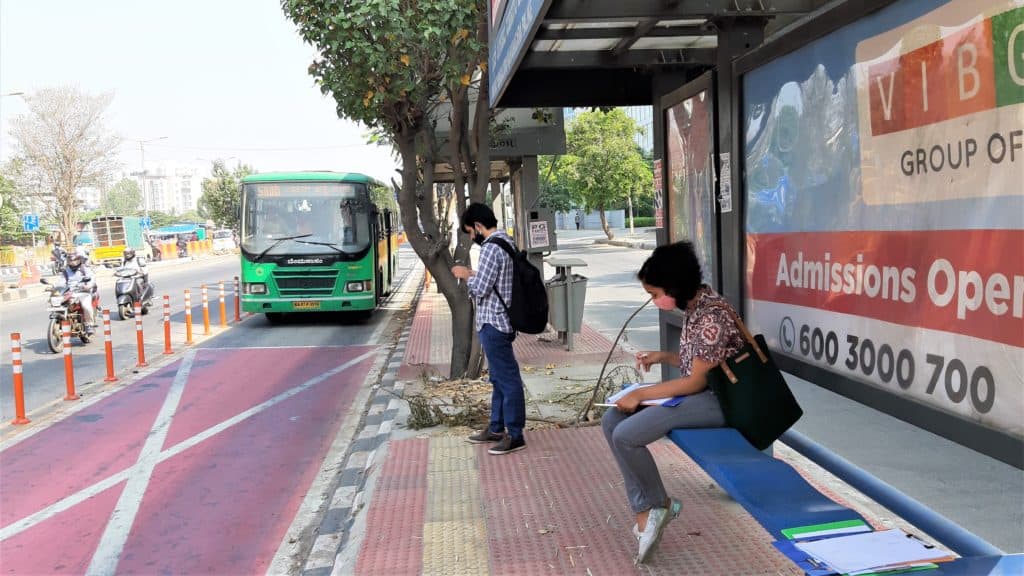 Commuters waiting at a bus stop on the bus priority lane (BPL) along Outer Ring Road, Bengaluru