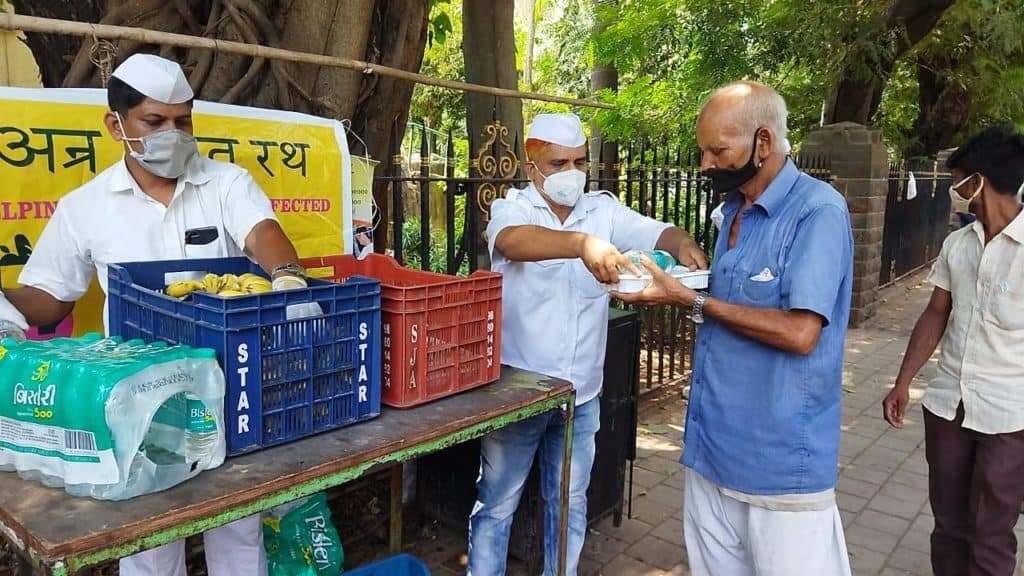 Mumbai dabbawalas distributing food to the needy people outside hospitals