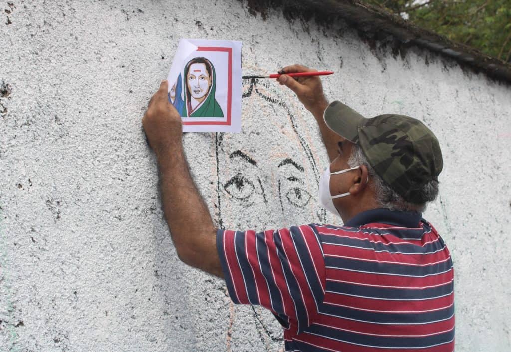 artist drawing a mural