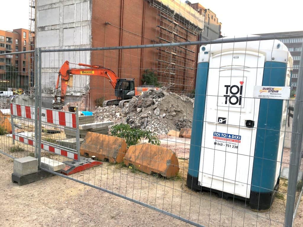 Portable toilets and fences at a construction site