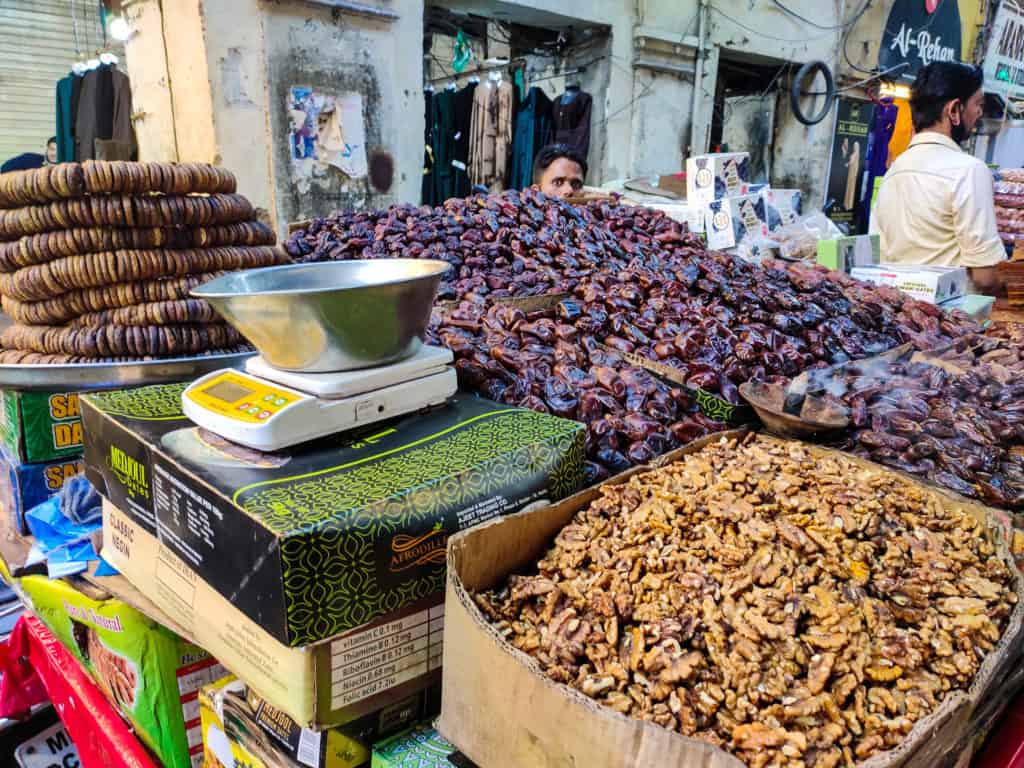 A hand cart full of dates, dried figs, apricots, walnuts and sweets on bhendi Bazaar streets.