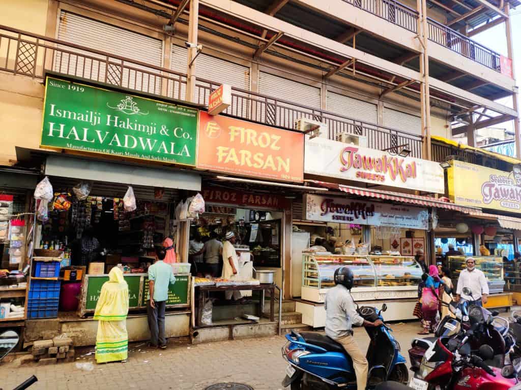 series of snack and sweet shops on a street in Bhendi Bazaar