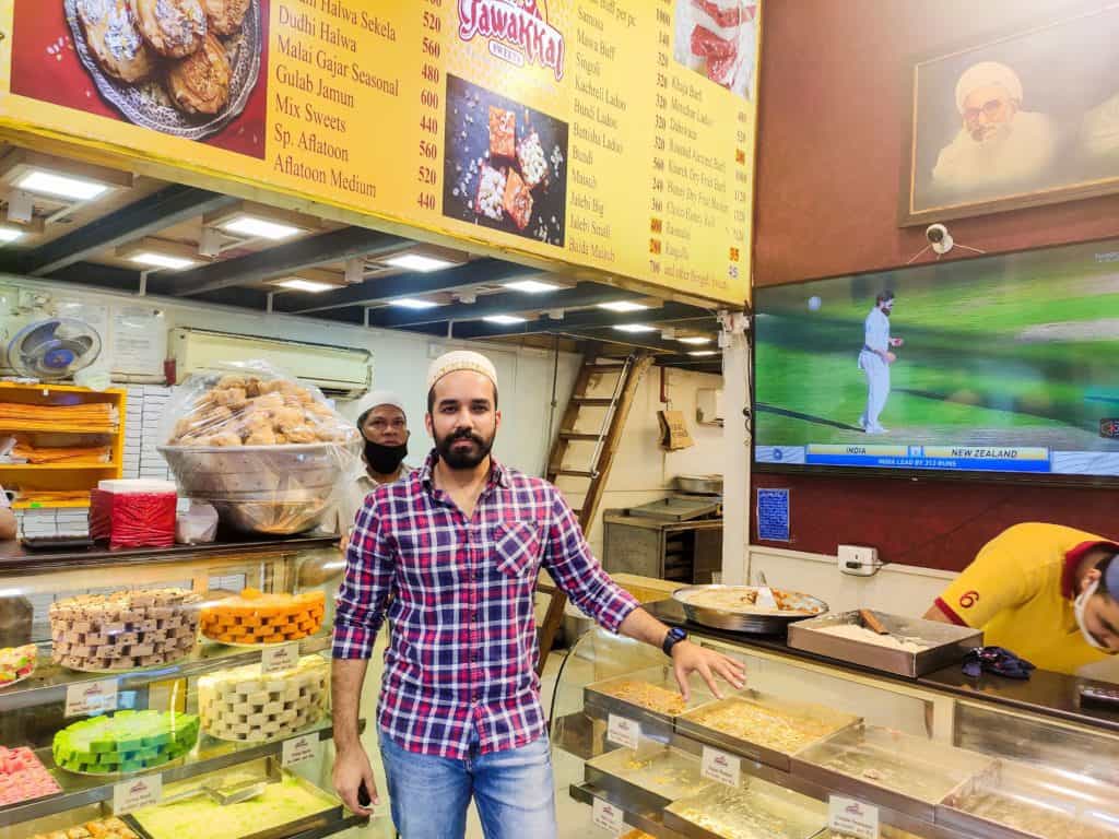 Portrait of the owner of Shabbir's Tawakkal in front of his sweet shop