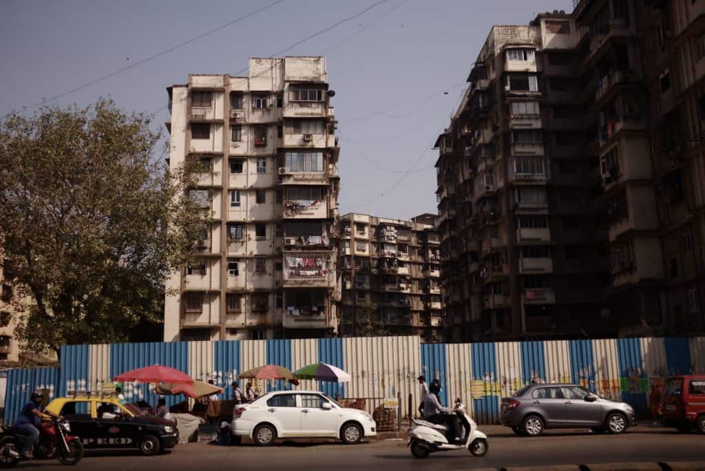 view of apartment buildings in Mumbai, on the side of a road 