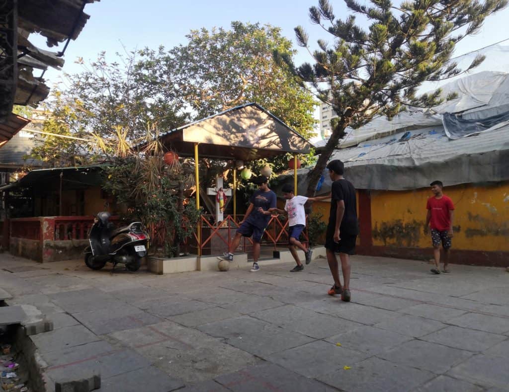 A game of football in the clearing of the Vile Parle gaothan
