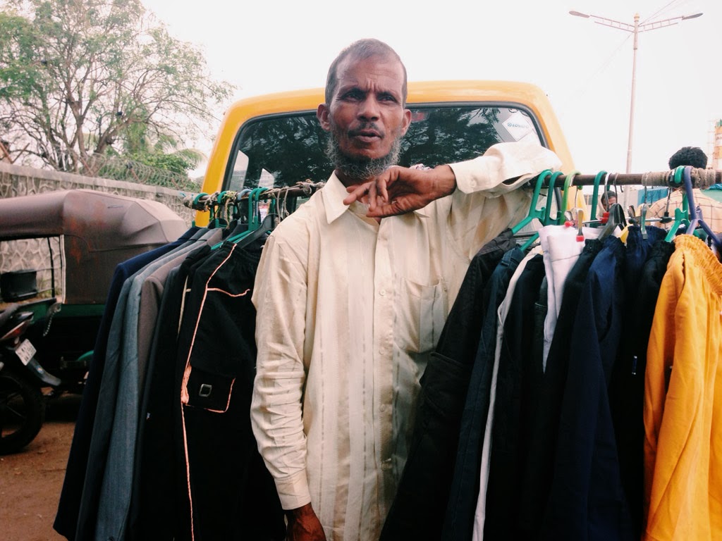 A hawker in Mumbai selling clothes on a rack