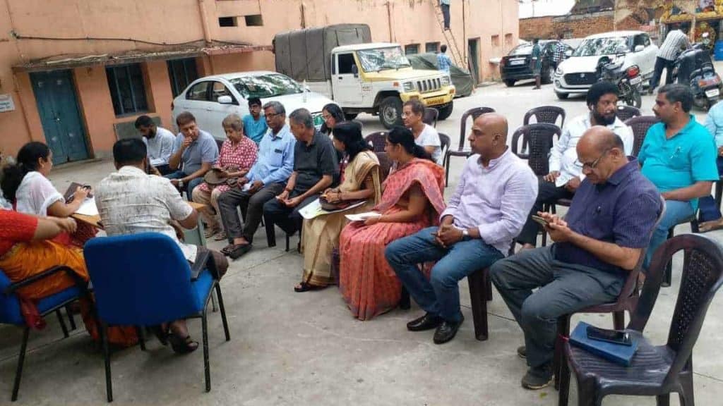 people at a ward committee meeting held outdoors