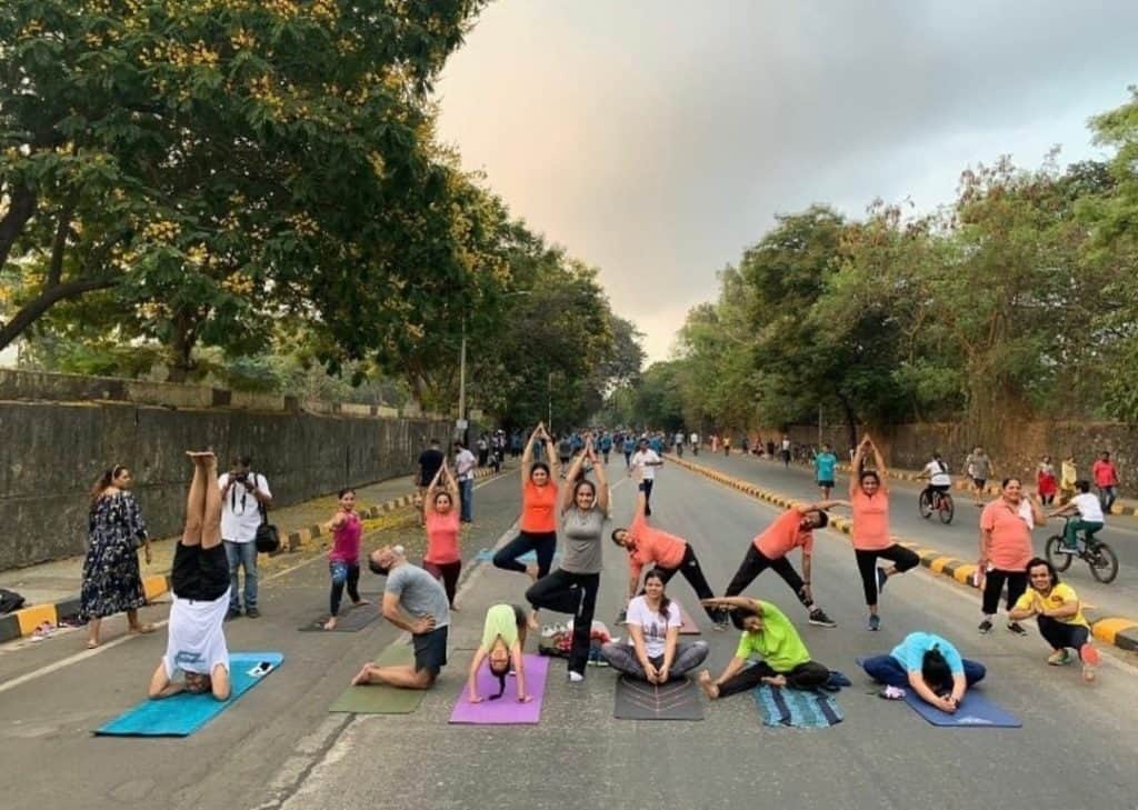 group of people doing yoga at a Sunday streets in Chembur.