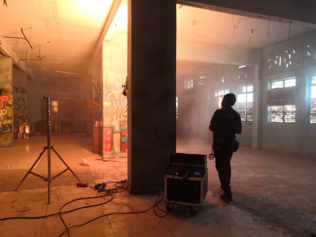 A scene on a film set created with smoke machines, grafiti and lighting