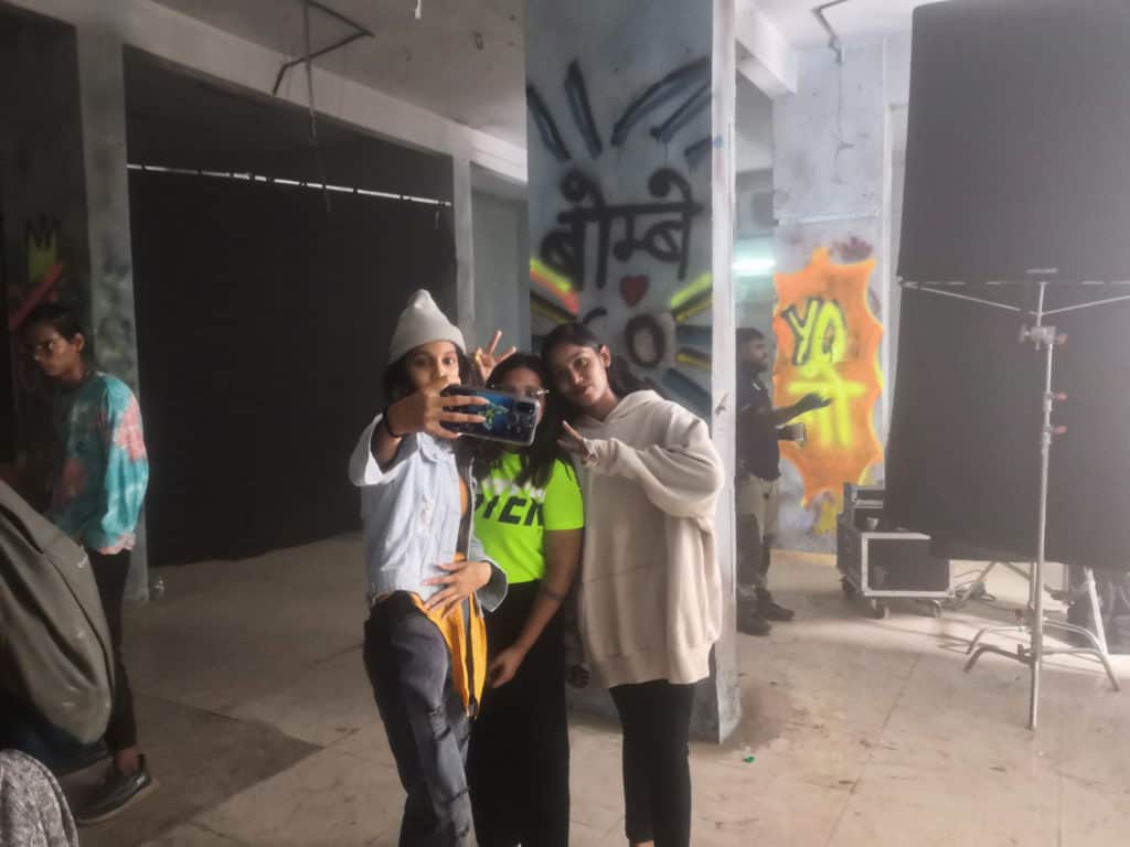 Three junior artists taking a selfie in between takes