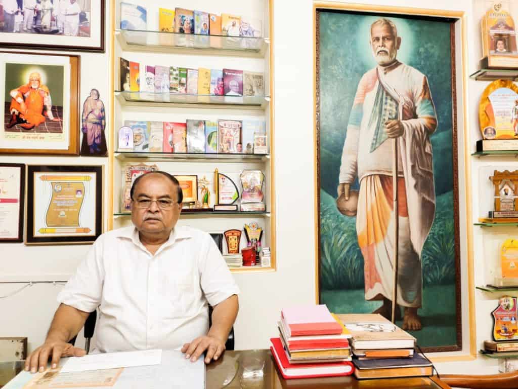 Trustee of the ghadge Maharaj Dharamshala poses for a photo in his office
