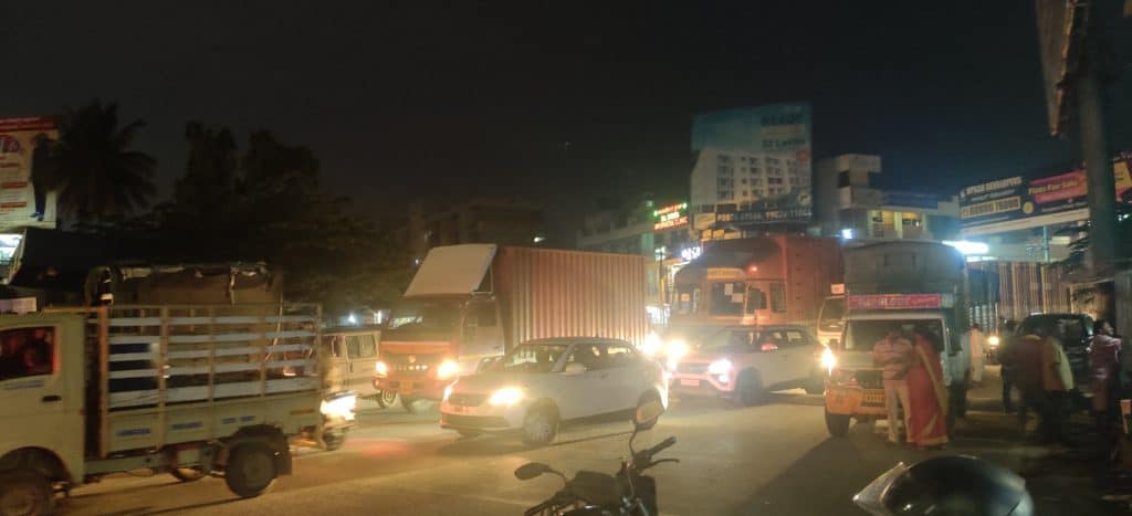 Road at night with heavy traffic, only lights from vehicles. 
