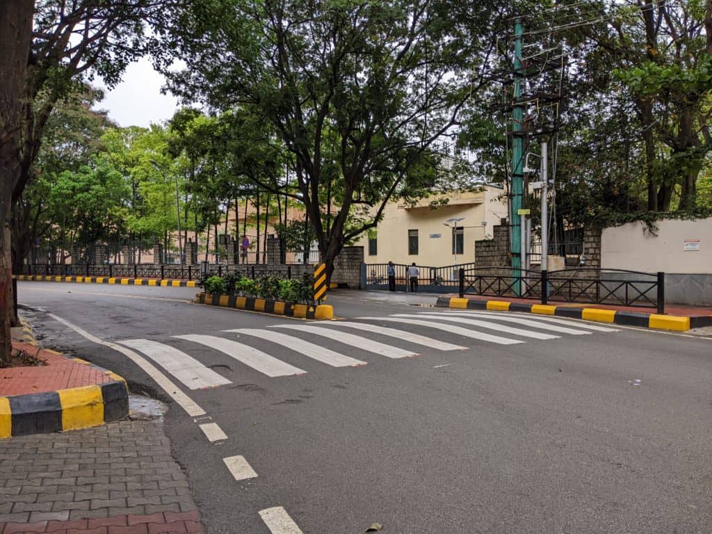 A smooth road with a raised zebra crossing. Footpaths in the far end.