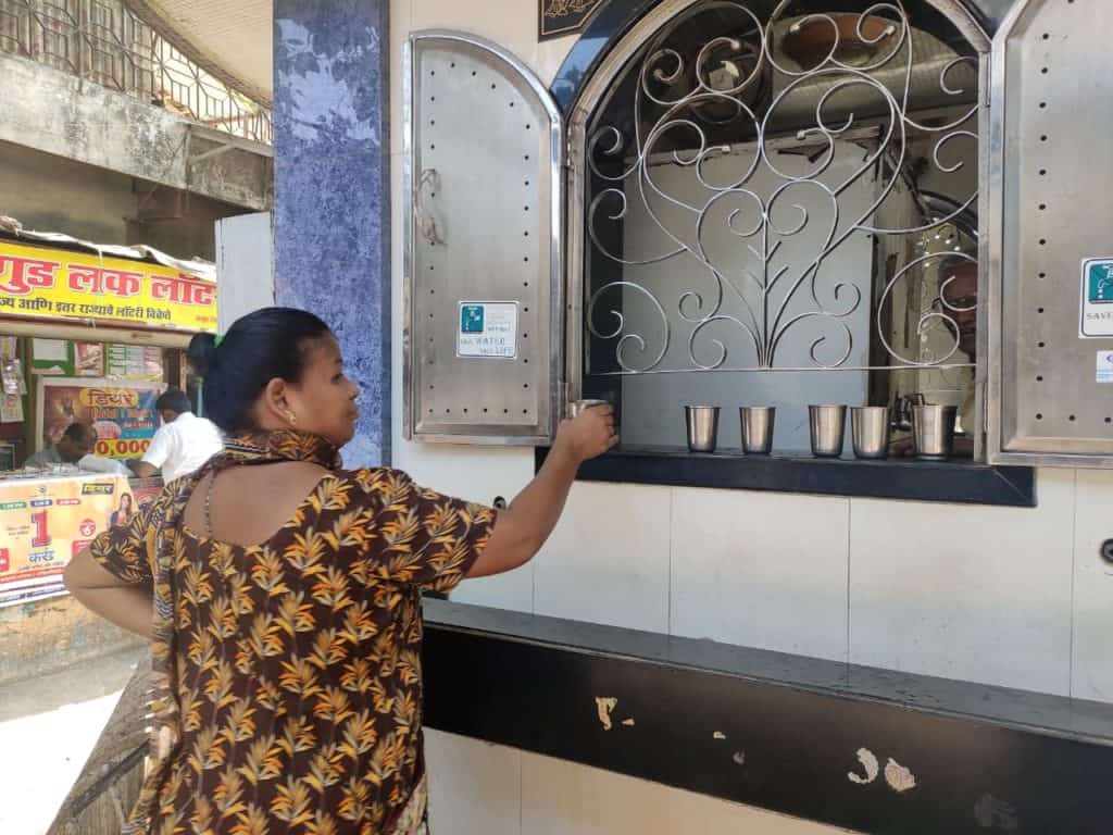 A woman drinking from a BMC water station in Goregaon