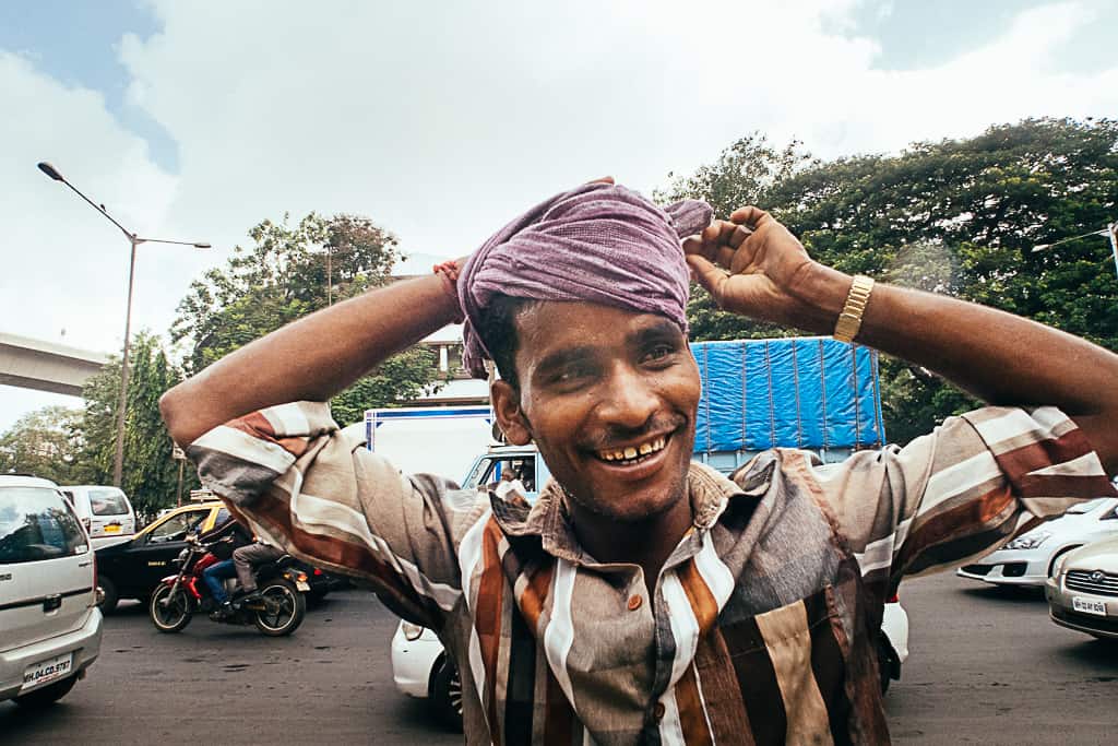 a street vendor in mumbai ties a handkerchief around his head