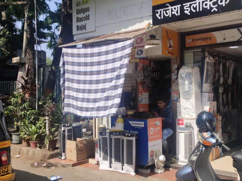 shop hung a bedsheet in the front of the shop to provide shade