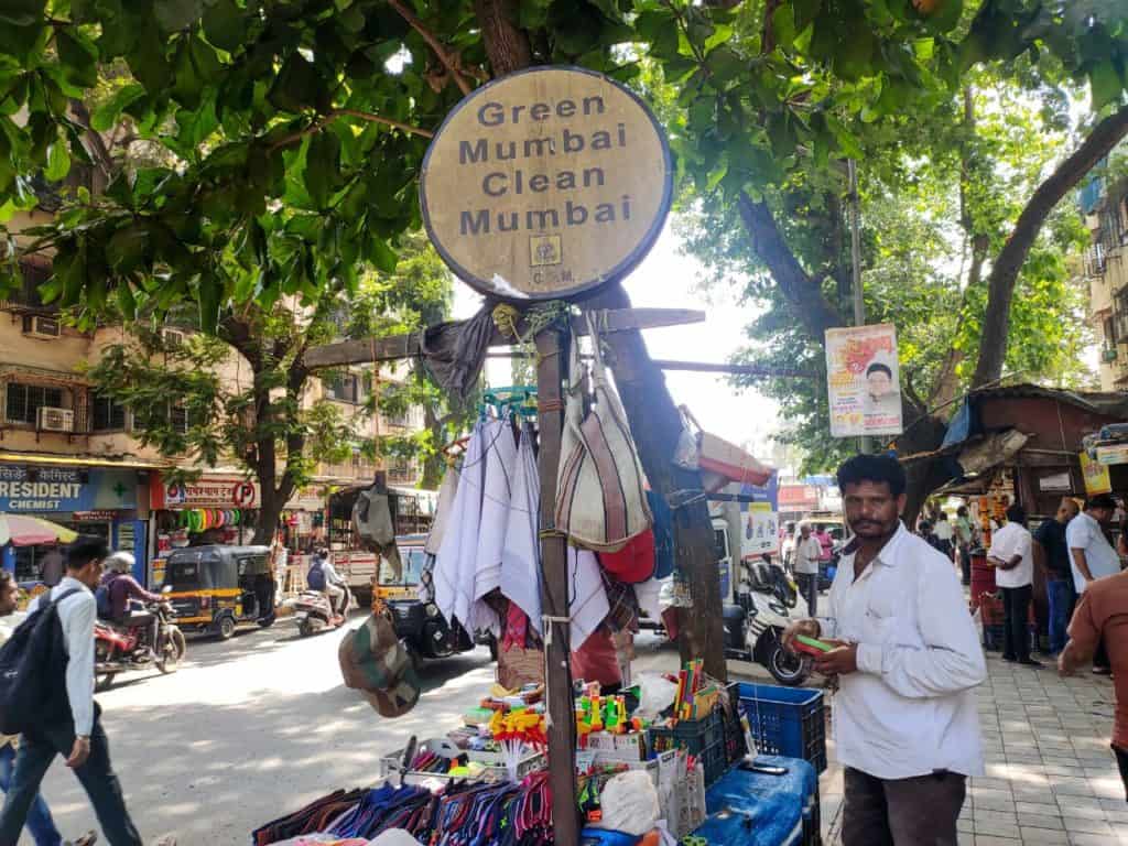 street vendor setting up shop under a tree
