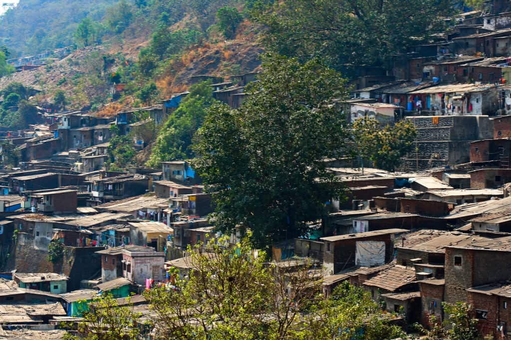 A slum in Vikhroli on the incline of a hill, with brick houses crowded together 