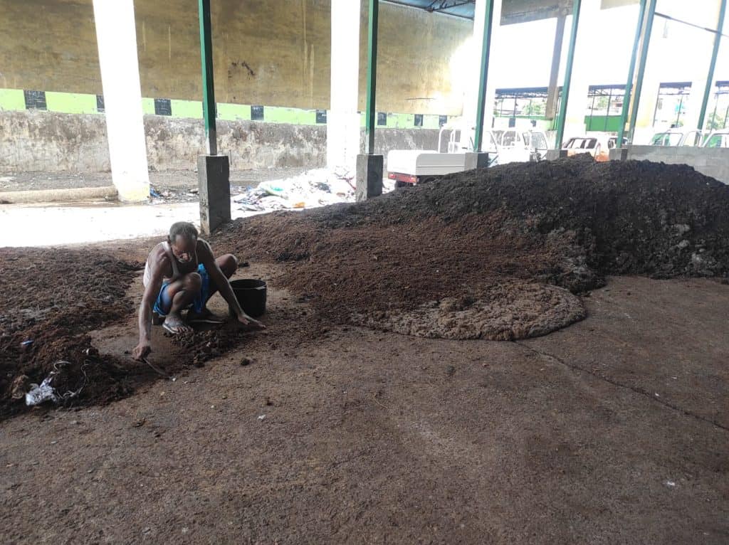 worker drying compost in Basin Bridge MCC