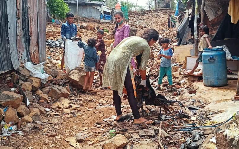 Women and children cleaning and picking up the garbage in Kranti Nagar to stop the waterlogging