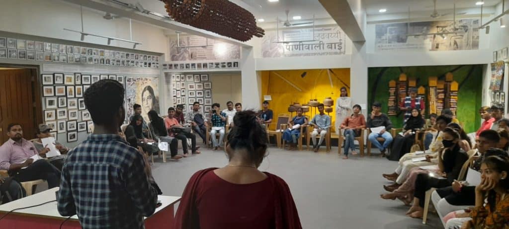 young students siting on chairs in a semicircle in a consultation session held by YUVA
