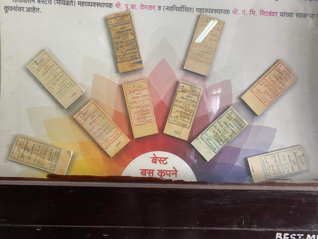 evolution of bus tickets displayed in a semi-circle under a glass case