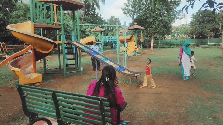 adults supervising children playing in a public space in mumbai