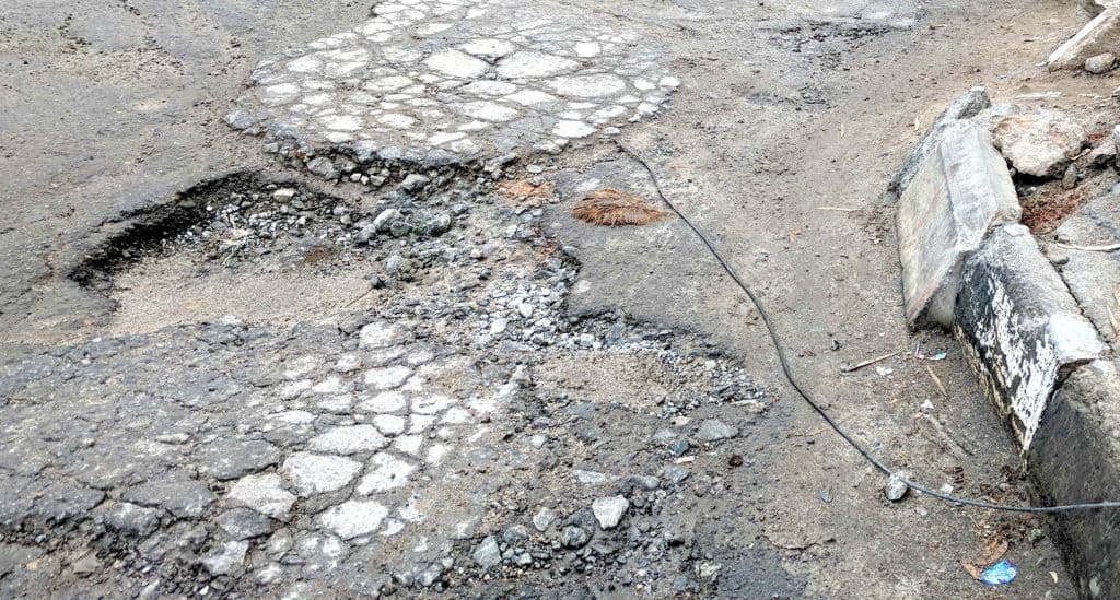 potholes and disintegrating road surface