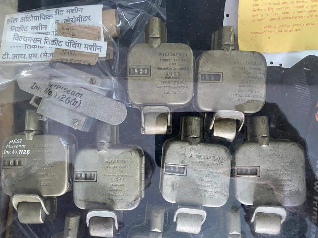 six old ticket punching machines under a glass case