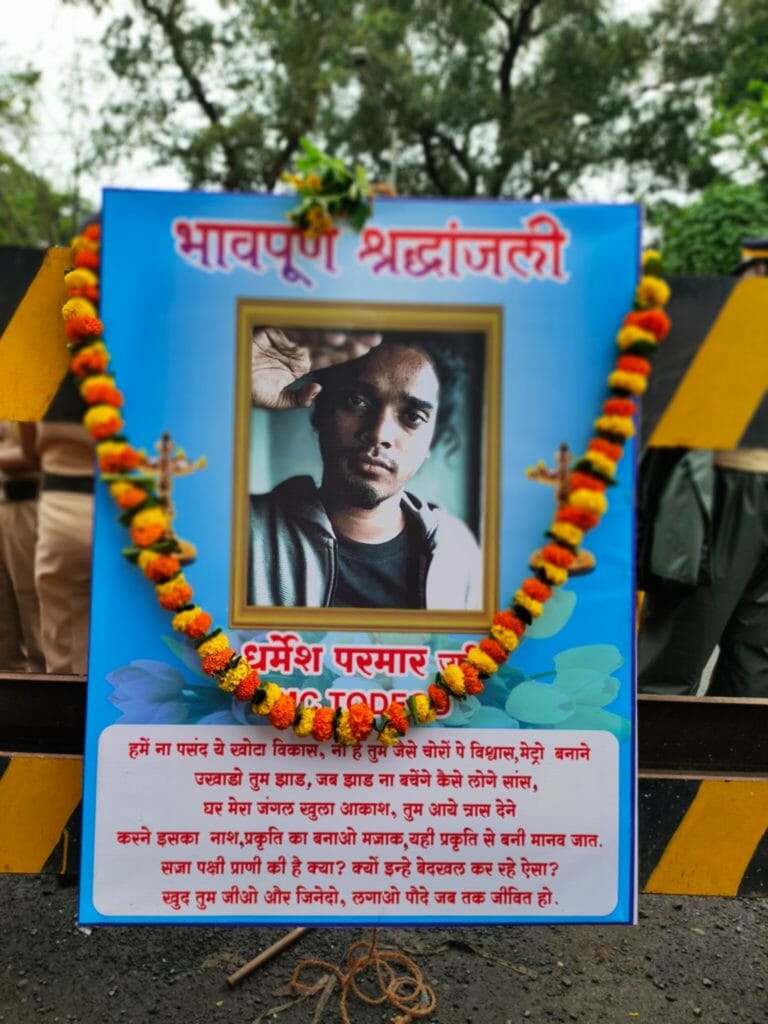 A poster of Dharmar Parmar, also known as MC Tod Fod, who died earlier this year. The poster is put up on barricades at Aarey. 