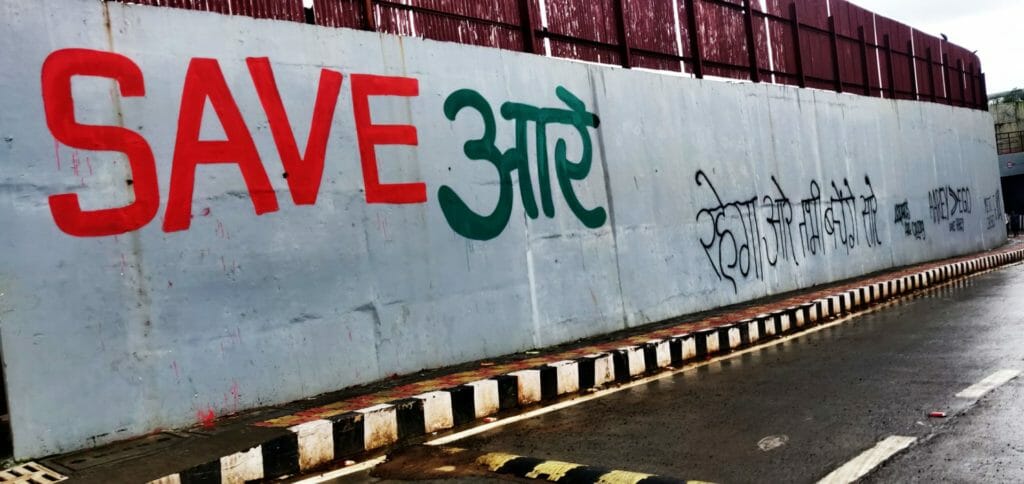 Save Aarey is written on the wall near the road leading to Aarey forest.
