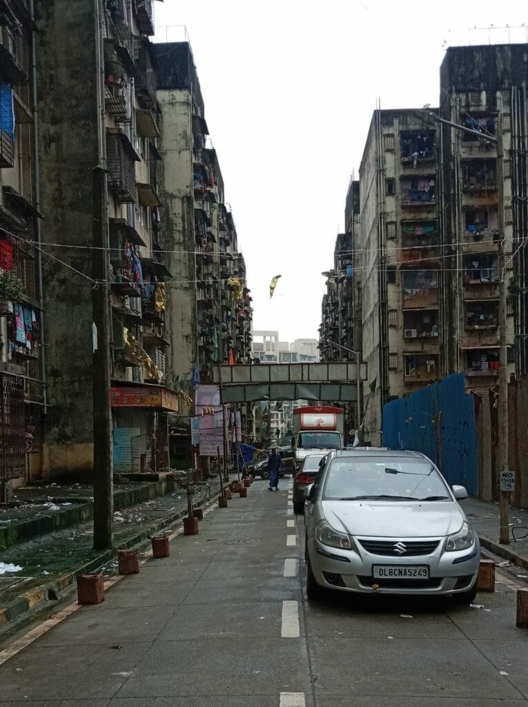 Two crammed buildings standing in opposite other on a narrow road in the slum resettlement site of Chandivali
