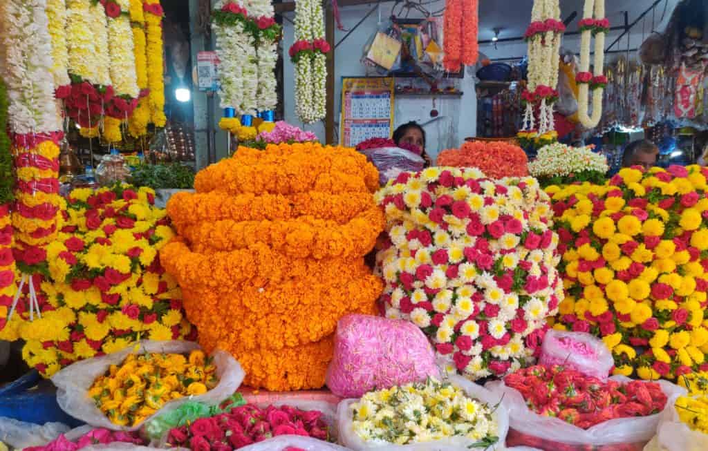 A flower vendor sits in Sarakki market