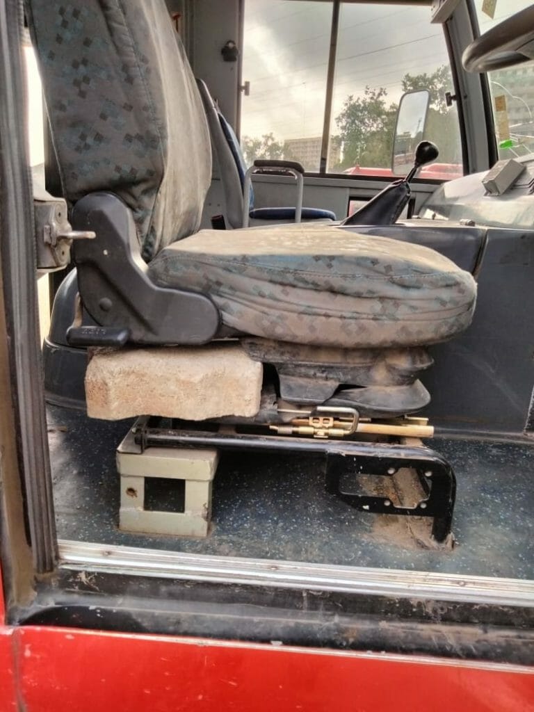 a bus seat in a BEST bus, supported by a paver block
