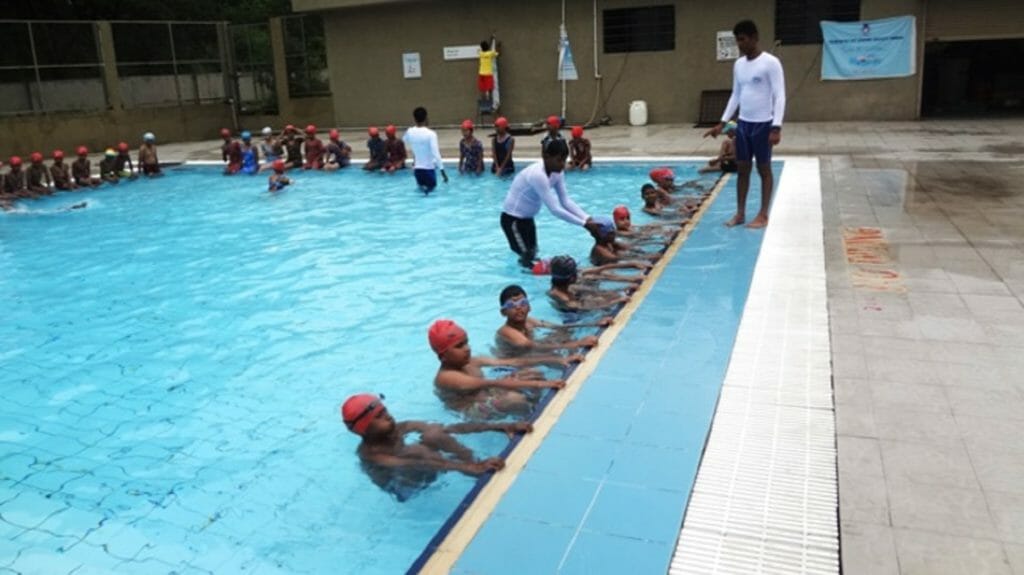 Children being trained in swimming pool