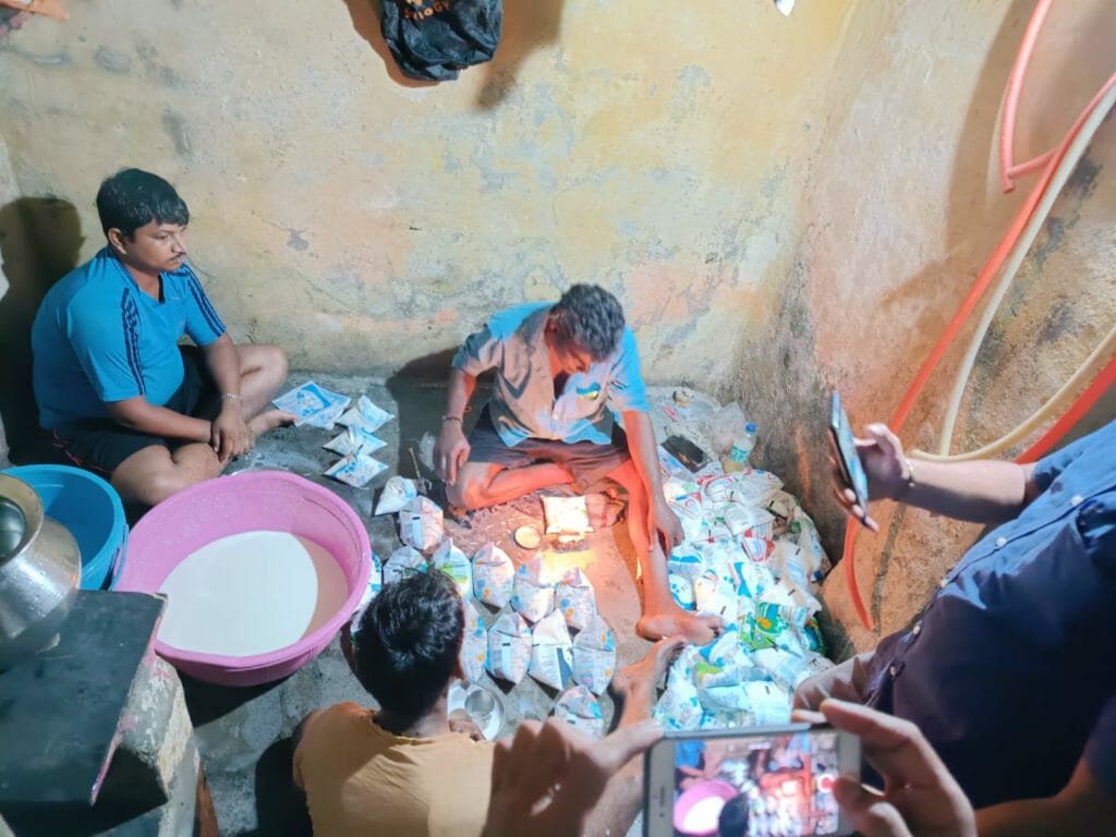 Officials from Mumbai Police and FDA conducting a raid at a milk adulteration racket.