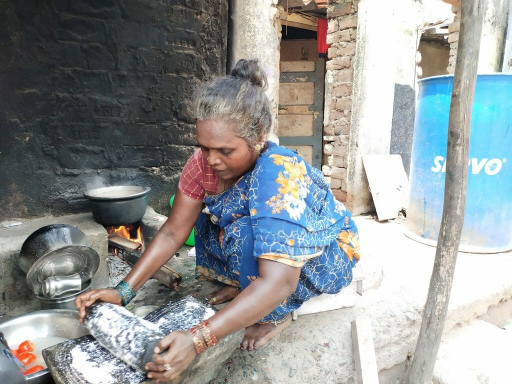 Woman in Thideer Nagar cooking in wood fire stove