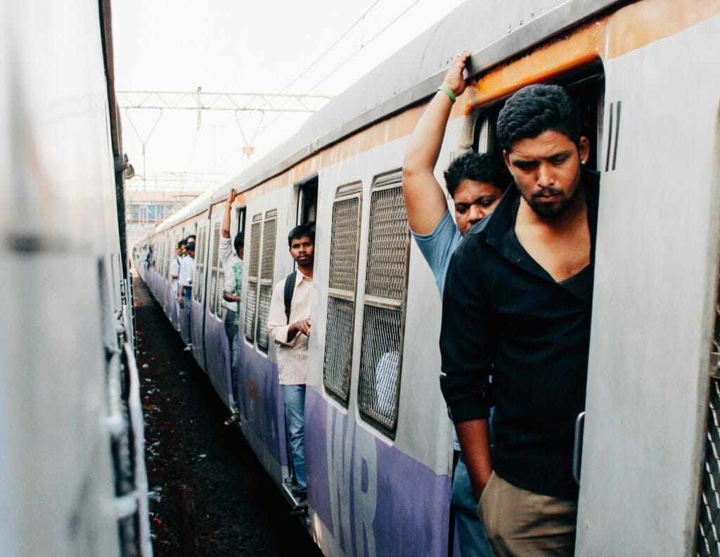 Men standing in a Mumbai local train.
