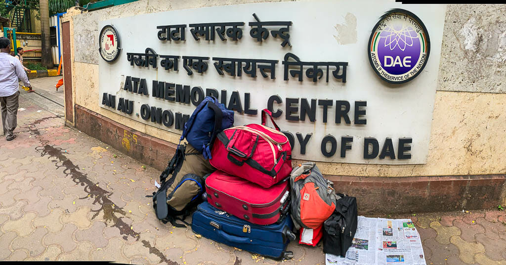 Board that is supposed to read Tata Memorial Centre reads Ata Memorial Centre. There are a lot of bags kept in front of it.