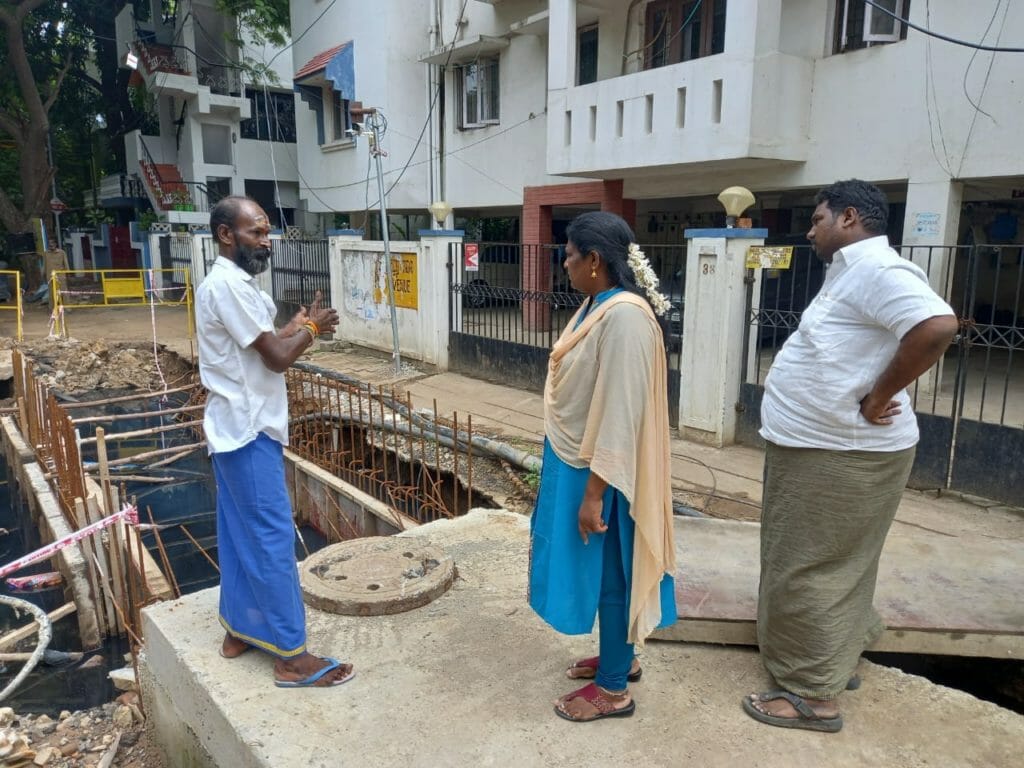Yazhini, ward 135 councillor checks stormwater drain work in Ashok Nagar