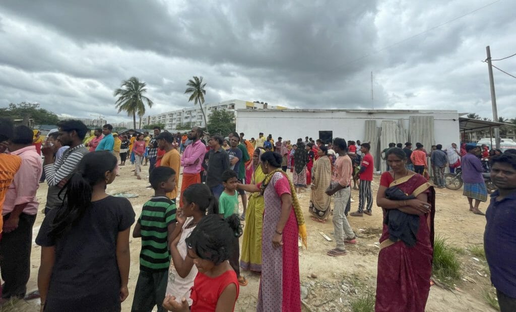 Urban slum dwellers gather to collect relief kits at Whitefield, Bengaluru