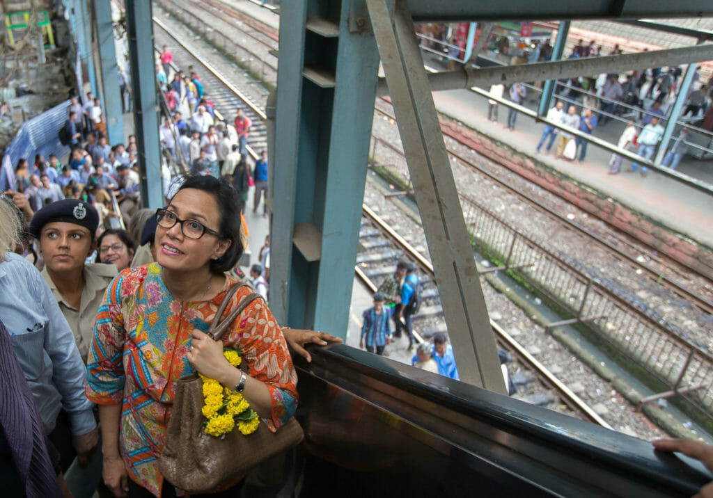 Women on an escalator in a train station in Mumbai