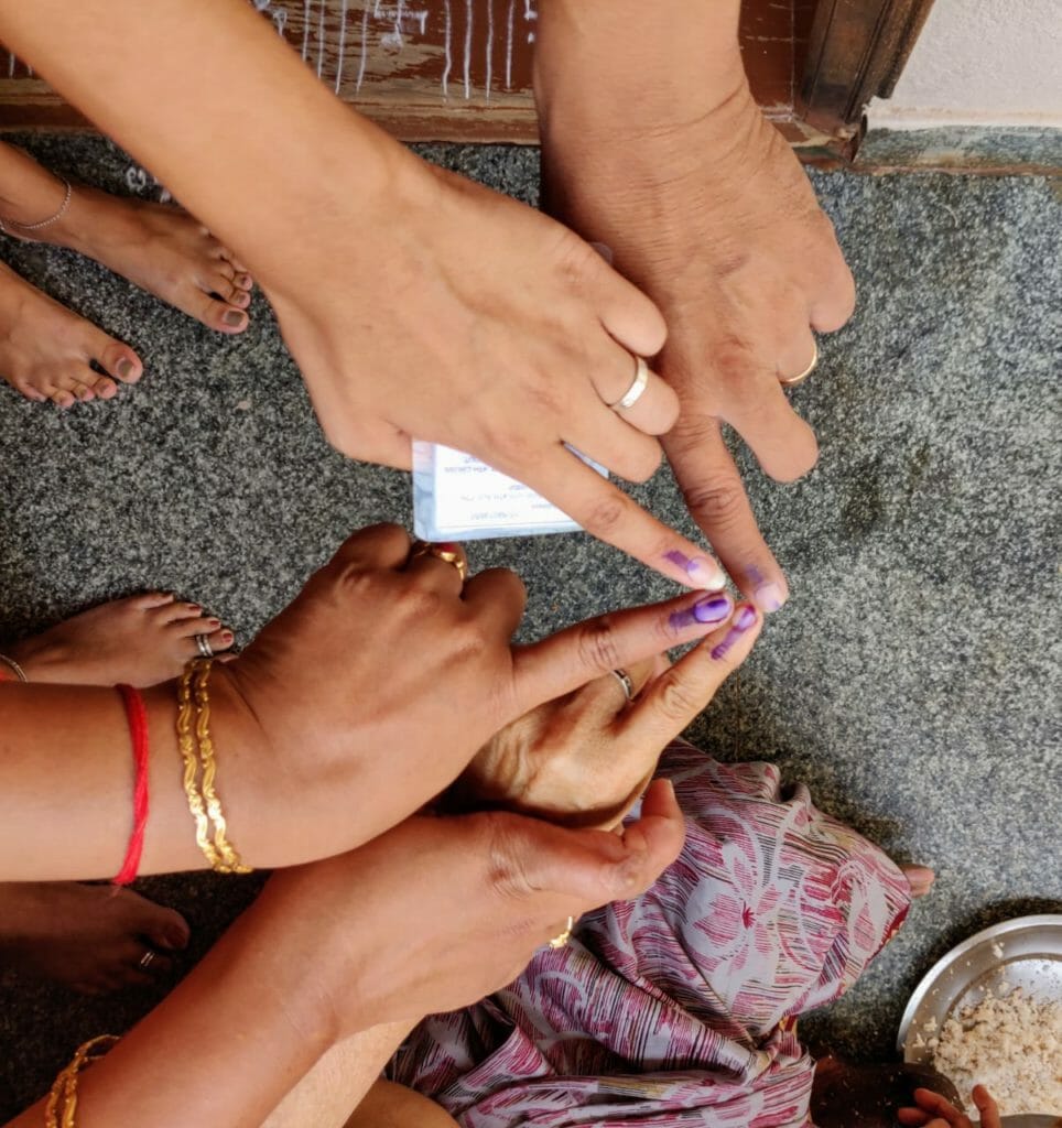 Voters displaying inked hands post casting their votes 