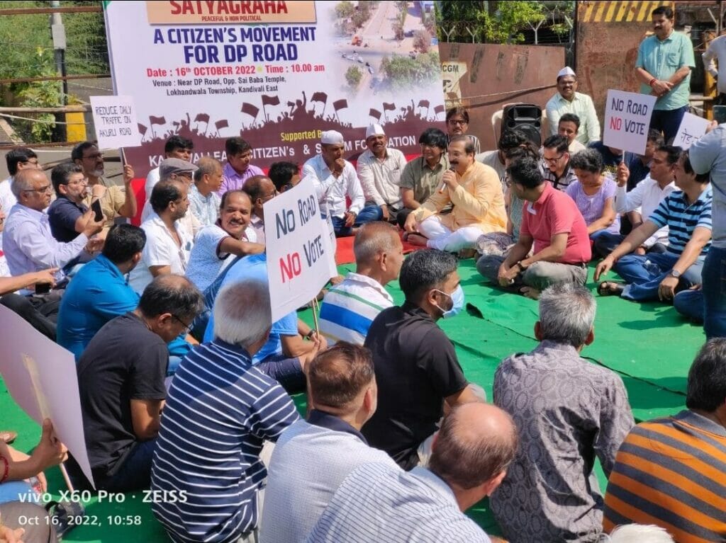 A group of men sitting in a circle with placards